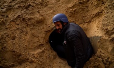 Israel claims a tunnel ran through this Gaza cemetery it destroyed. A visit to the site raised more questions than answers. Pictured is CNN's correspondent