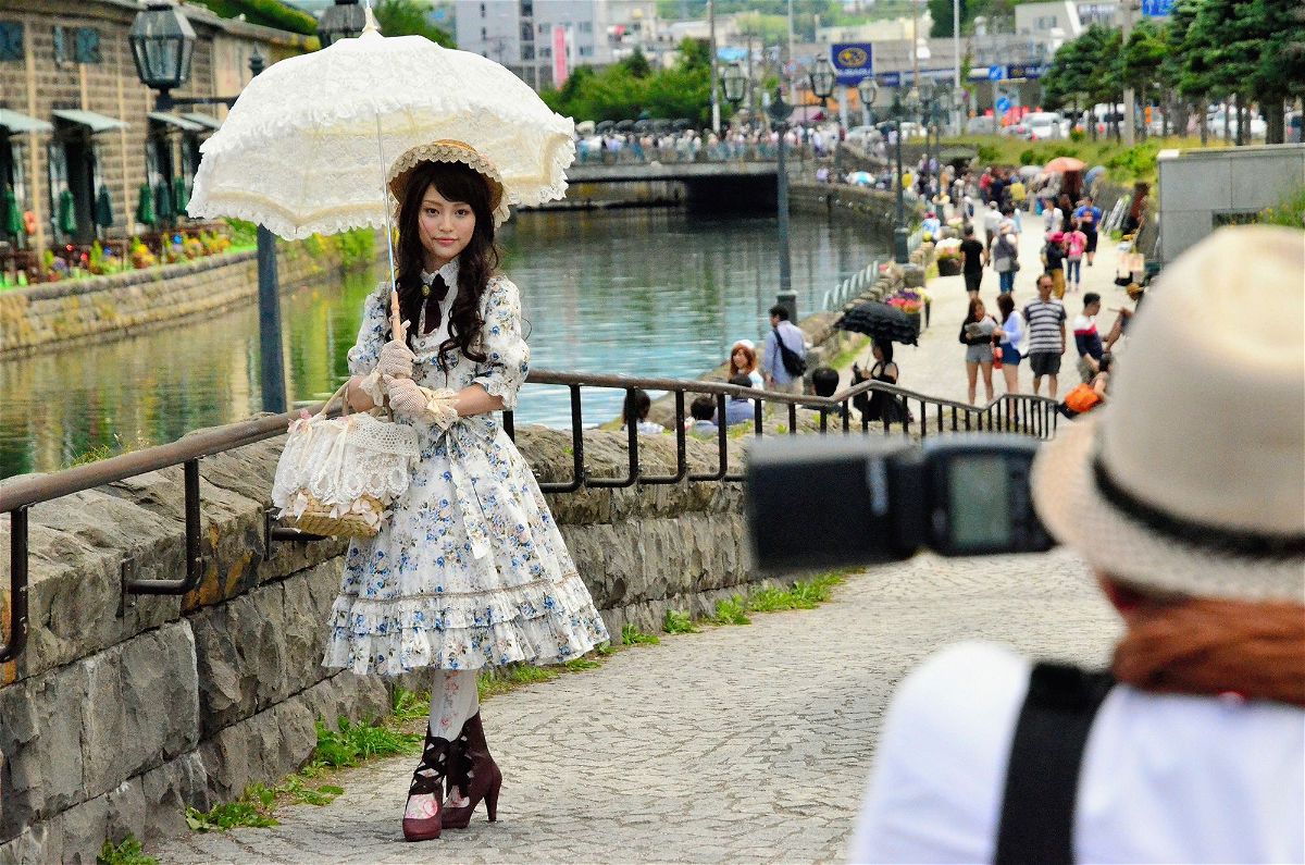<i>The Asahi Shimbun/Getty Images</i><br/>A young woman sporting Lolita fashion poses for photographs along the Otaru Canal in the background on June 29