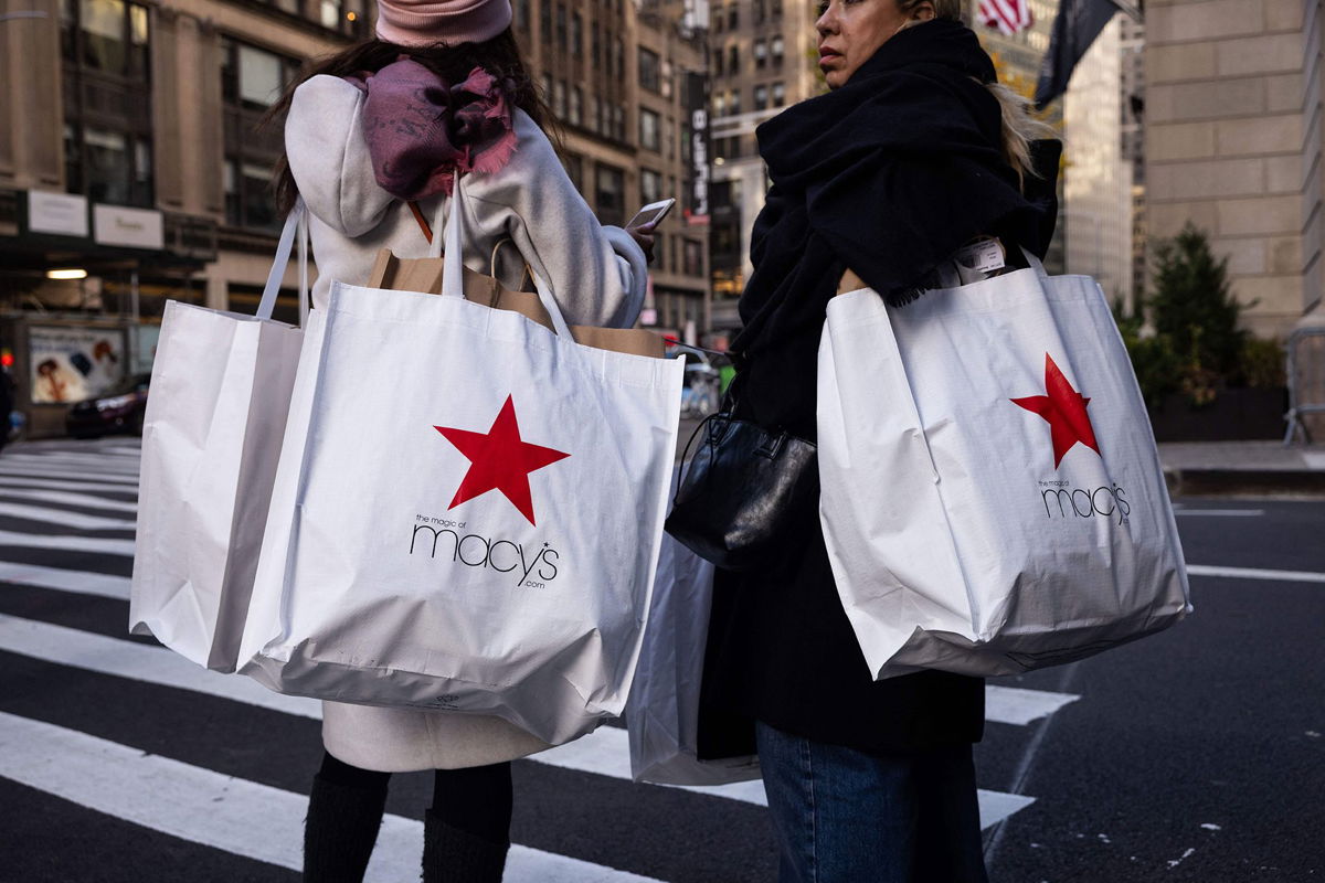 <i>Yuki Iwamura/AFP/Getty Images</i><br/>Shoppers carry Macy's bags during 