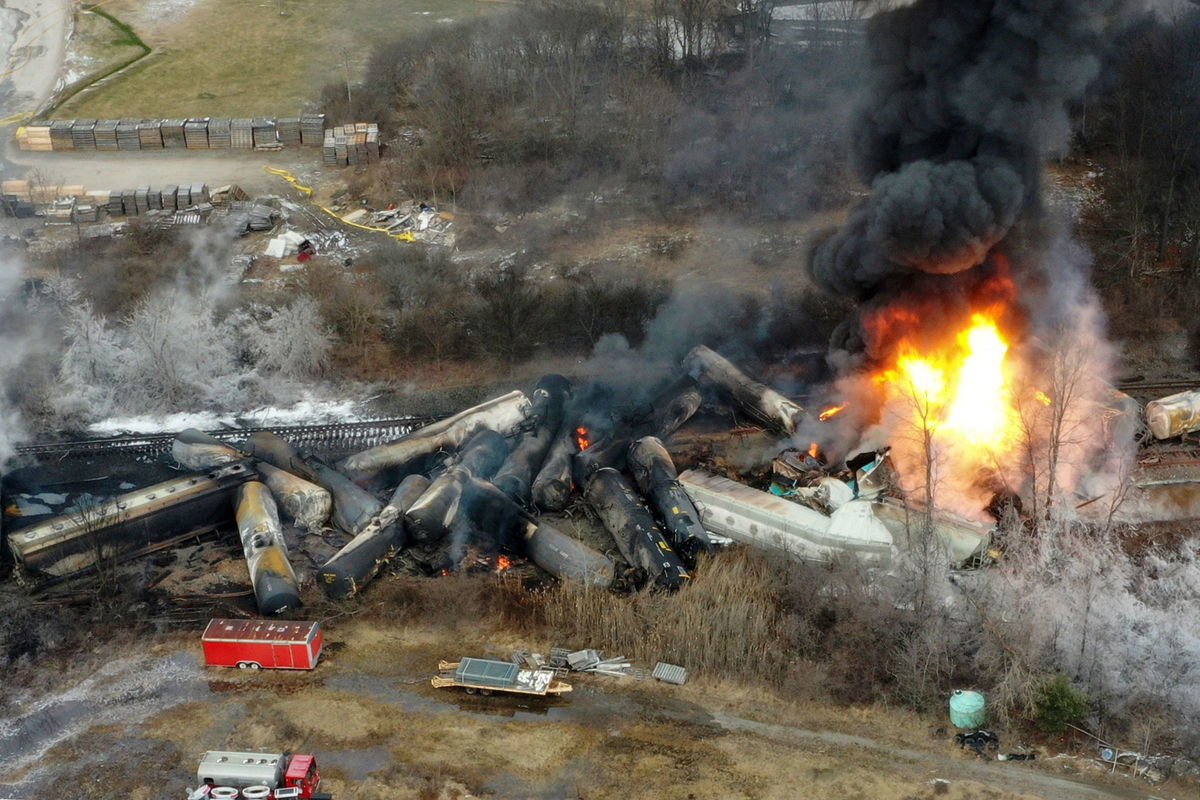 <i>Gene J. Puskar/AP</i><br/>Portions of a Norfolk Southern freight train that derailed the night before burn in East Palestine