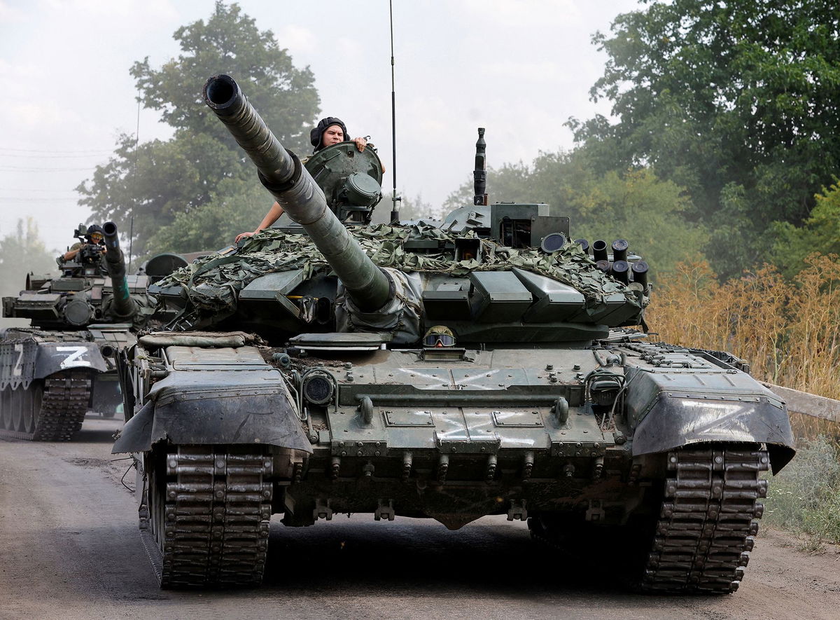 <i>Alexander Ermochenko/Reuters</i><br/>Russian tanks drive near the settlement of Olenivka in Donetsk region