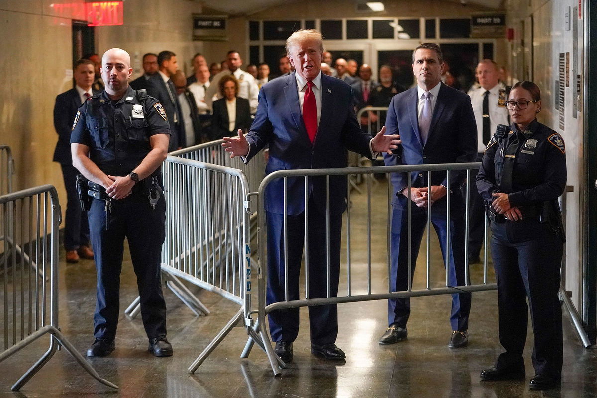 <i>Mary Altaffer/AP</i><br/>Former President Donald Trump speaks before entering the courtroom at Manhattan criminal court