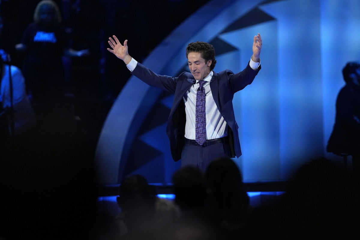 Pastor Joel Osteen prays during a service at Lakewood Church on February 18, in Houston.