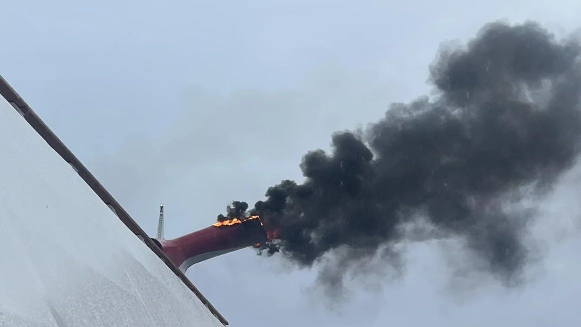 Heath Barnes took this photo of fire and smoke pouring out of an exhaust funnel of the Carnival Freedom cruise ship near the Bahamas, on March 23. 