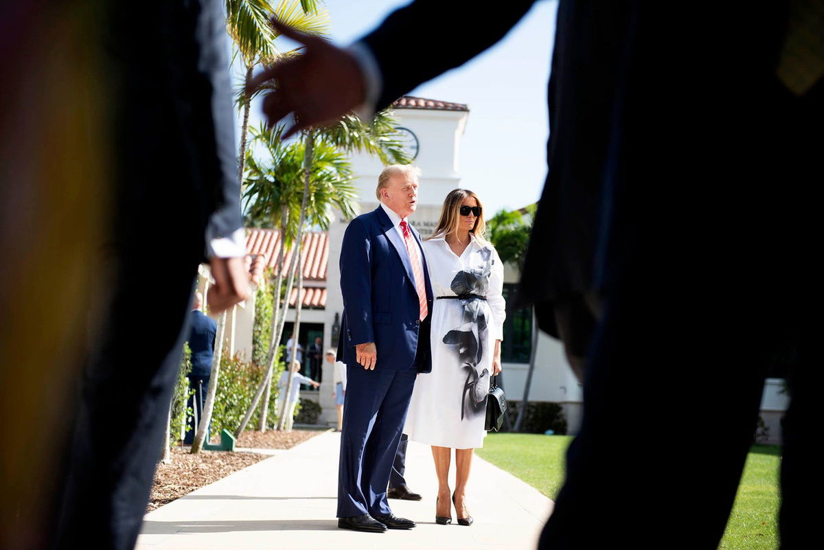 <i>Meghan McCarthy/USA Today Network via CNN Newsource</i><br/>Donald and Melania Trump stand in front of members of the media after casting their votes in Palm Beach