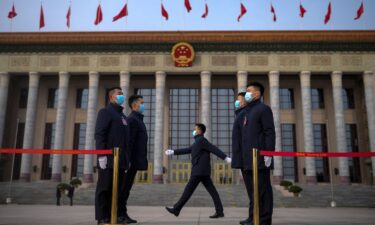 Soldiers dressed as ushers stand guard outside the Great Hall of the People ahead of the opening of the National People's Congress (NPC) in Beijing.