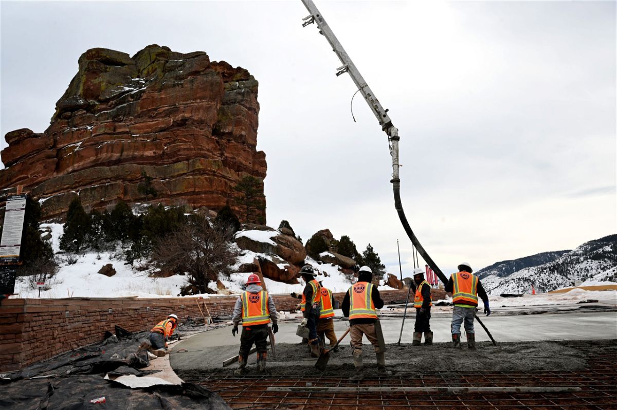 <i>Helen H. Richardson/MediaNews Group/The Denver Post/Getty Images via CNN Newsource</i><br/>Construction workers pour concrete in the upper parking lot at Red Rocks Park and Amphitheatre on February 6