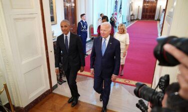 President Joe Biden and first lady Jill Biden along with former President Barack Obama and former first lady Michelle Obama arrive in the East Room of the White House in Washington