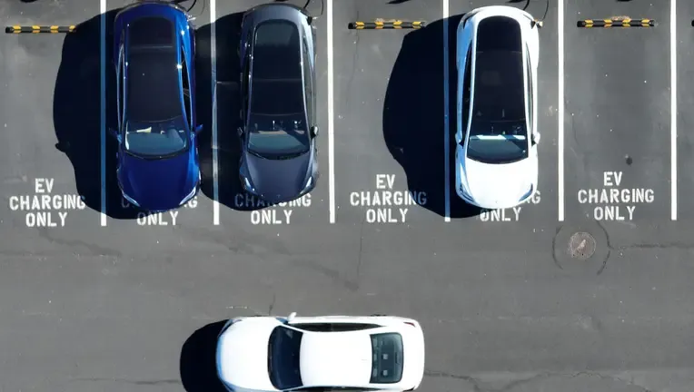 In an aerial view, Tesla cars recharge at a Tesla charger station on February 15, 2023 in Corte Madera, California