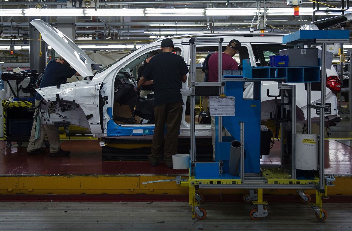 <i>Andrew Caballero-Reynolds/AFP/Getty Images via CNN Newsource</i><br/>Employees install parts on a Mercedes-Benz SUV as it moves down the production line at its factory in  Vance