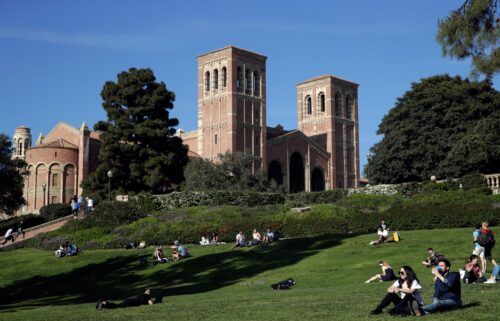 Students sit on the lawn near Royce Hall at the University of California