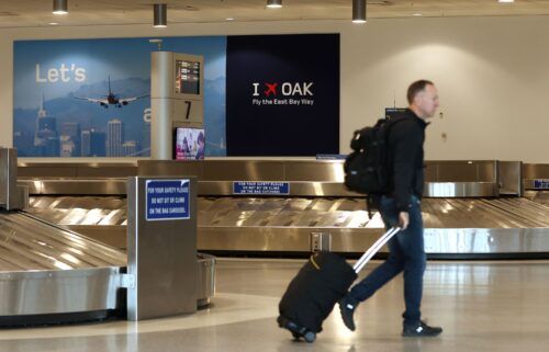 A traveler walks through baggage claim in Terminal 2 at Oakland International Airport on April 12.