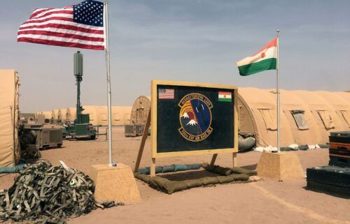 A U.S. and Niger flag are raised side by side at the base camp for air forces and other personnel supporting the construction of Niger Air Base 201 in Agadez