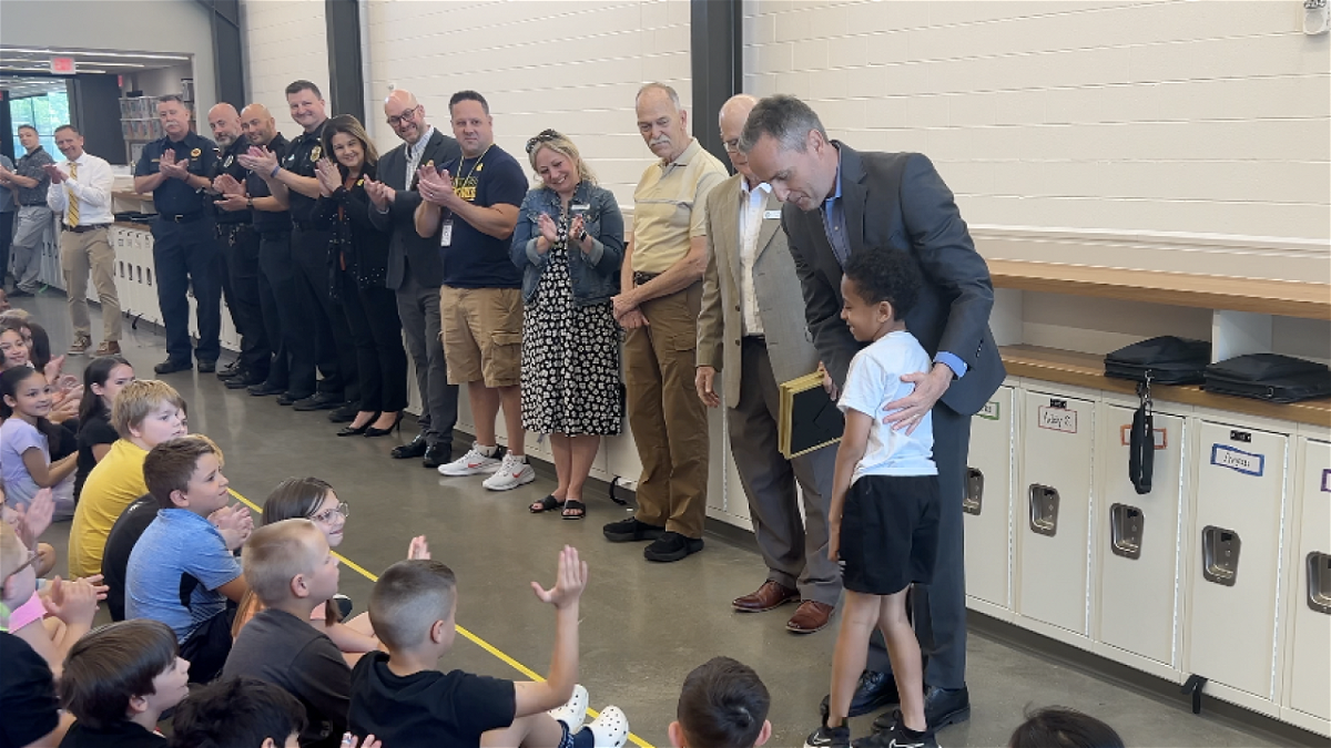 <i>WEWS via CNN Newsource</i><br/>Superintendent Steve Wood congratulates second grader Trey Lewis for alerting others when a classmate had a severe allergic reaction to a granola bar.