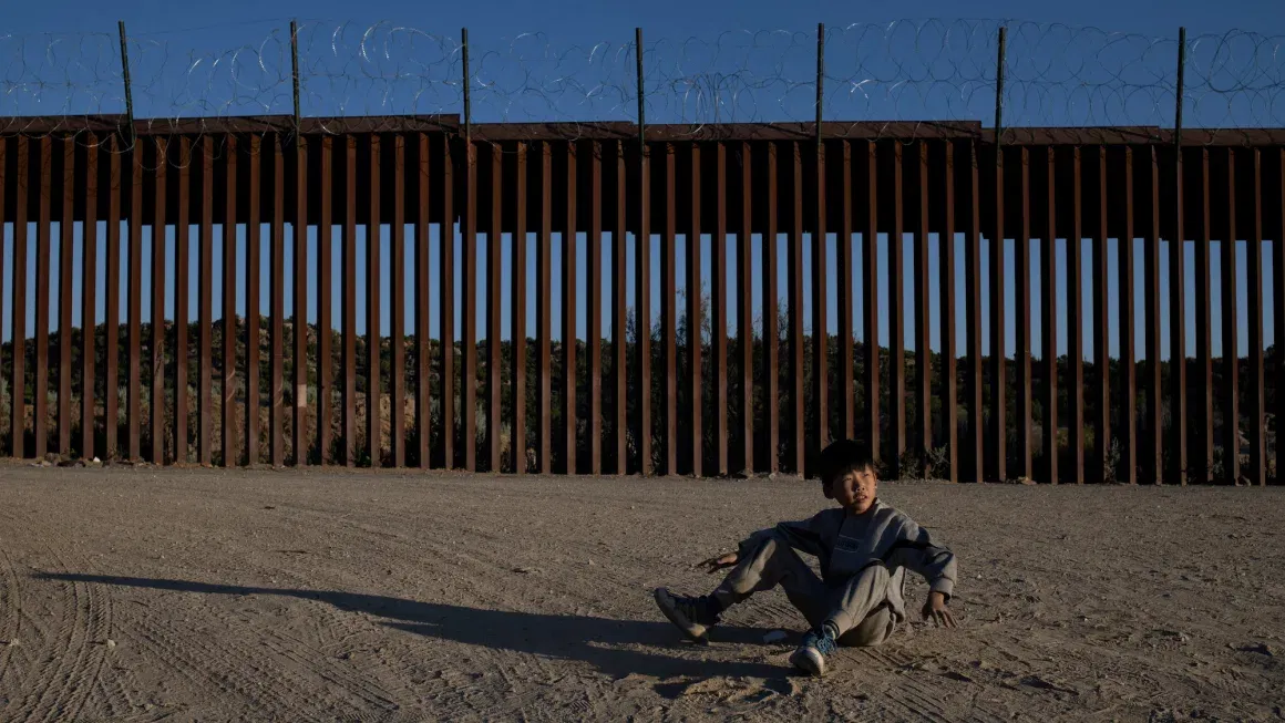 Zhu, a 10-year-old asylum-seeking migrant from Henan Province, China, plays near the border wall after his family crossed into the United States from Mexico in Jacumba Hot Springs, California, U.S., May 13, 2024