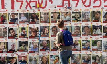 A women looks at photos of hostages held by Hamas in Gaza on May 1