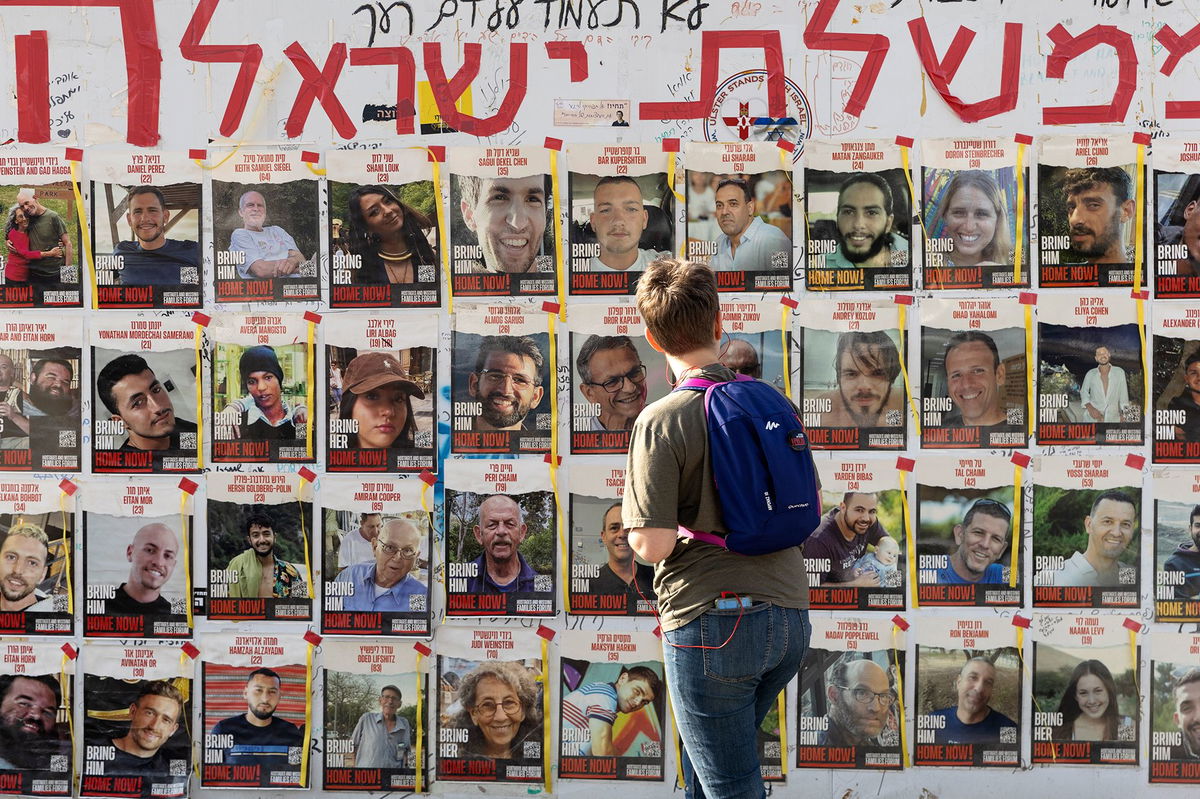 <i>Amir Levy/Getty Images via CNN Newsource</i><br/>A women looks at photos of hostages held by Hamas in Gaza on May 1