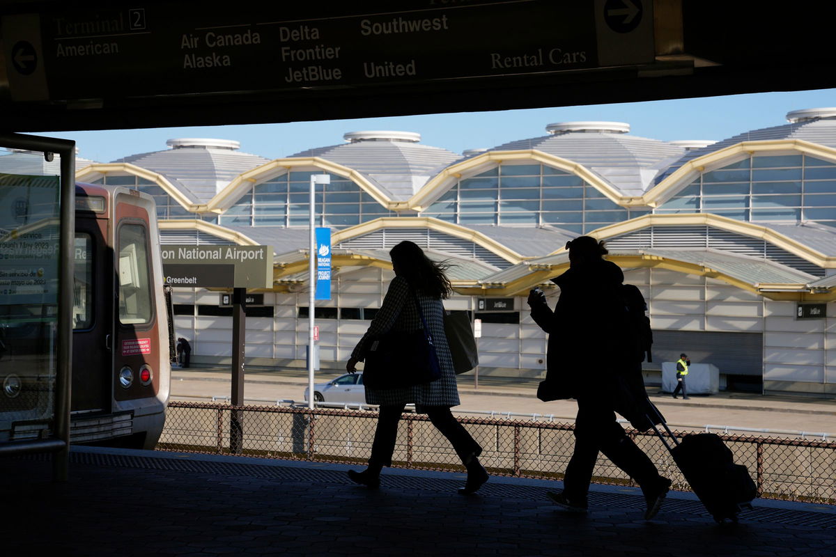 <i>Patrick Semansky/AP/File via CNN Newsource</i><br/>Travelers run to a waiting Metro train across from a terminal at Ronald Reagan Washington National Airport in Arlington