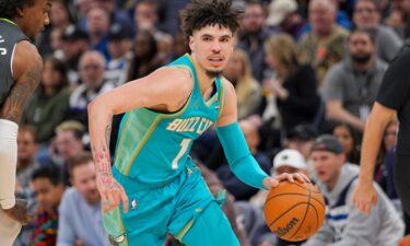 LaMelo Ball looks on from the bench during the first quarter of the Charlotte Hornets' game against the Atlanta Hawks at State Farm Arena on March 23.