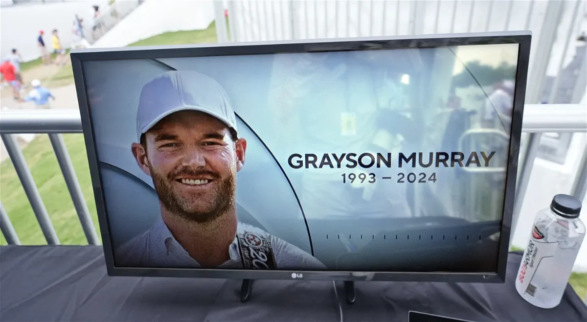 A golf television broadcast is played at the broadcast tent showing a photo of Grayson Murray during the third round of the Charles Schwab Challenge. 