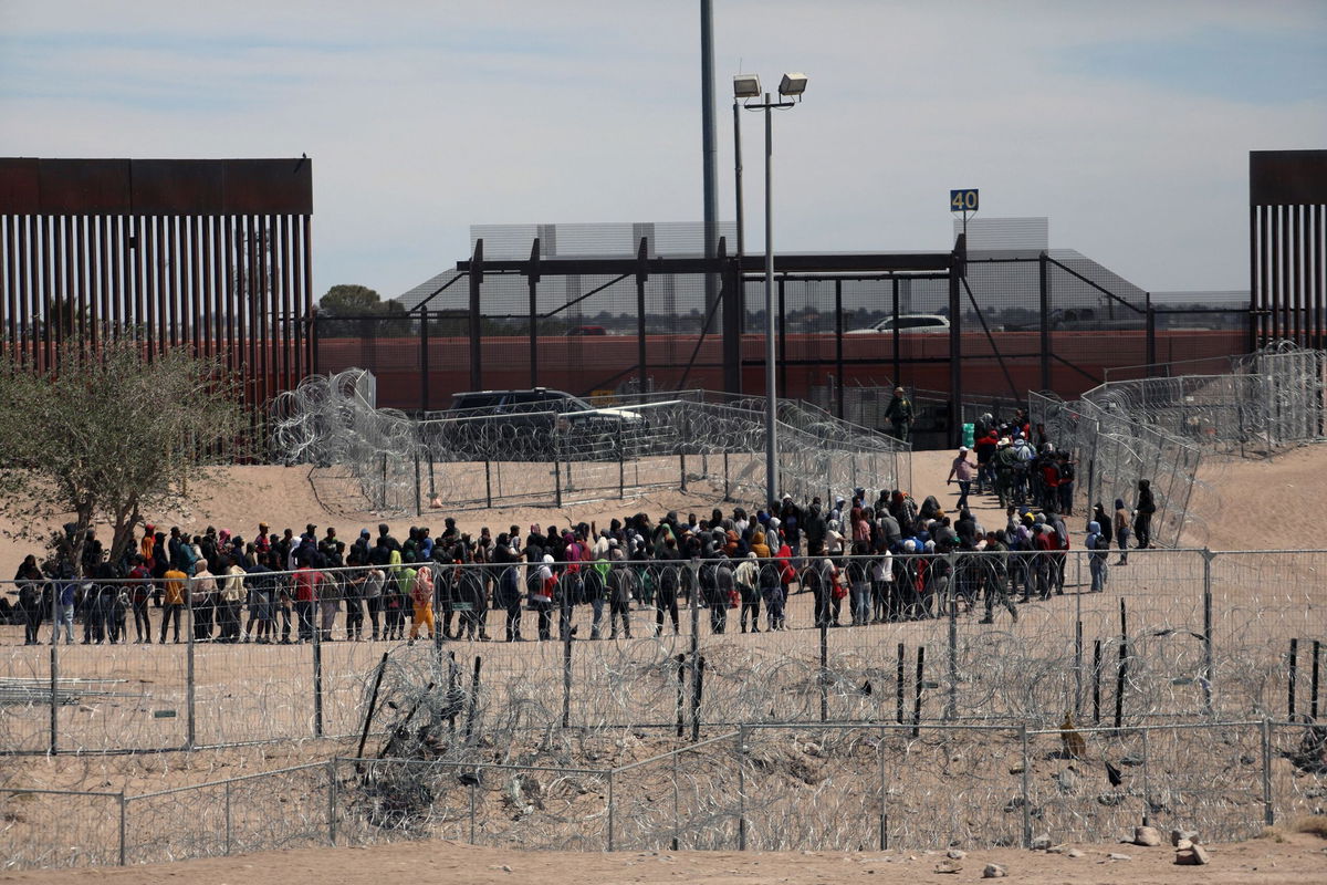 Migrants line up to be transferred by US Border Patrol in El Paso, Texas, on April 18. The Biden administration plans to immediately invoke an authority to shut off access to asylum for migrants who cross the US-Mexico border illegally.