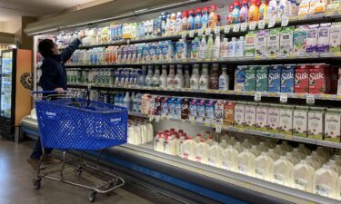 A customer shops for milk at a grocery store in December 2023 in San Anselmo