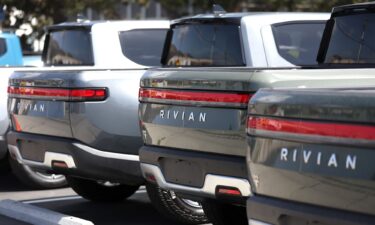 Rivian electric pickup trucks sit in a parking lot at a Rivian service center in May 2022 in South San Francisco