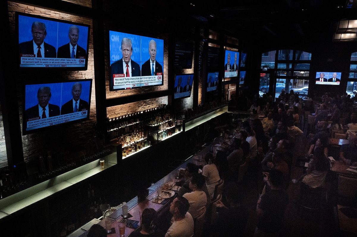 <i>Scott Olson/Getty Images via CNN Newsource</i><br/>Guests at the Old Town Pour House watch the debate between President Joe Biden and presumptive Republican nominee former President Donald Trump on June 27