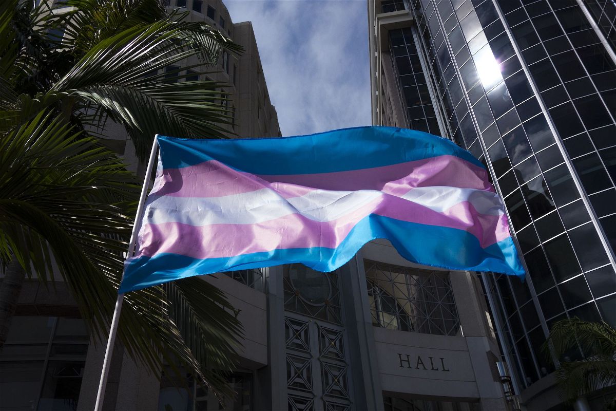 <i>Alex Menendez/AP/File via CNN Newsource</i><br/>A transgender flag is seen waving during a gathering at City Hall in Orlando