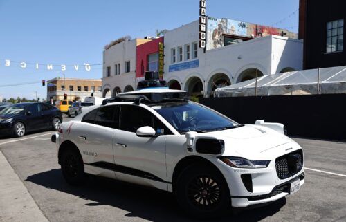A Waymo autonomous self-driving Jaguar taxi drives near Venice Beach on March 14
