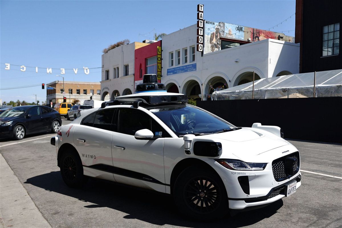 <i>Mario Tama/Getty Images/File via CNN Newsource</i><br/>A Waymo autonomous self-driving Jaguar taxi drives near Venice Beach on March 14