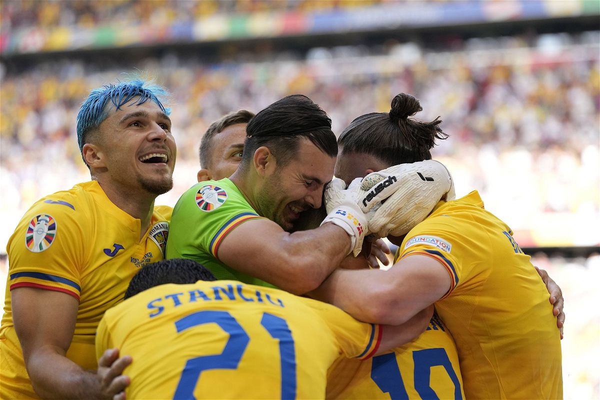 <i>Antonio Calanni/AP via CNN Newsource</i><br/>Romania's players celebrate during their victory against Ukraine on June 17.