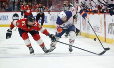 Brandon Montour of the Florida Panthers and Leon Draisaitl of the Edmonton Oilers play the puck in Game 5 of the 2024 Stanley Cup Final at the Amerant Bank Arena on June 18.