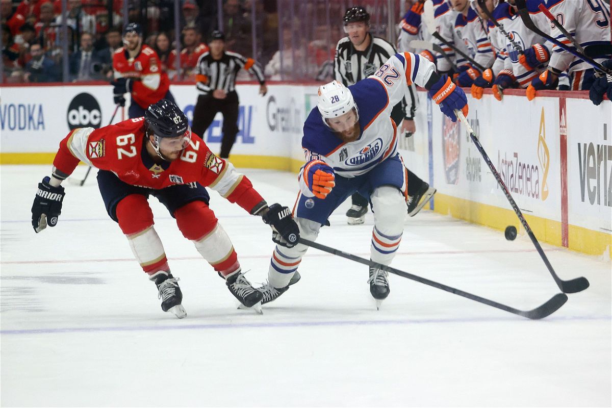 <i>Joel Auerbach/Getty Images via CNN Newsource</i><br/>Brandon Montour of the Florida Panthers and Leon Draisaitl of the Edmonton Oilers play the puck in Game 5 of the 2024 Stanley Cup Final at the Amerant Bank Arena on June 18.