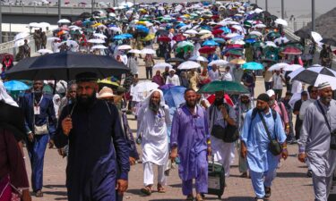 Muslim pilgrims use umbrellas to shield themselves from the sun.