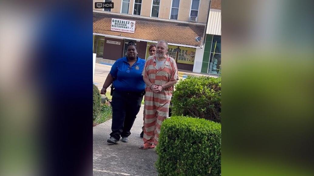 <i>KTBS via CNN Newsource</i><br/>Greg Lawson is escorted to the Claiborne Parish Courthouse Monday.