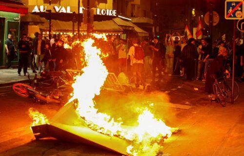 A barricade burns as protesters demonstrate against the far right in Paris