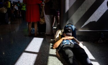 A passenger takes a nap inside a terminal at Harry Reid International Airport on July 19