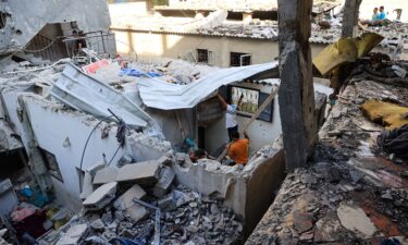 Palestinians asses the damage following an Israeli strike in the Nuseirat refugee camp in the central Gaza Strip on July 6