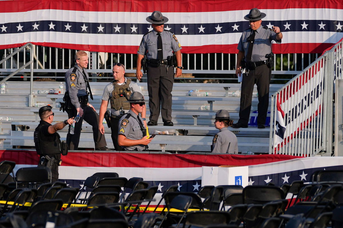 <i>Evan Vucci/AP via CNN Newsource</i><br/>Rico Elmore spoke to CNN as he walked away from the rally stage. His white shirt was stained with blood from the victim