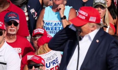 Former President Donald Trump is helped off the stage at a campaign event in Butler