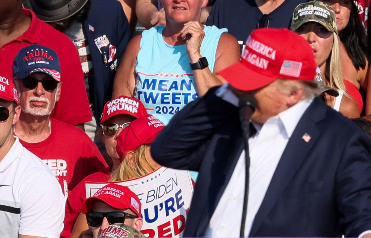 <i>Gene J. Puskar/AP via CNN Newsource</i><br/>Former President Donald Trump is helped off the stage at a campaign event in Butler