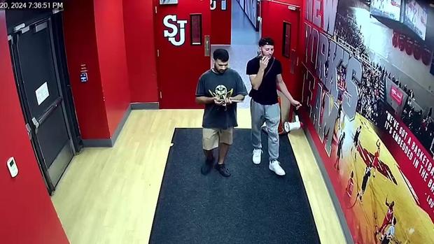 <i>NYPD/WCBS/WLNY via CNN Newsource</i><br/>The NYPD says this surveillance shows the suspects holding a ceremonial sword and bullhorn burglarized from St. John University Coach Rick Pitino's office.