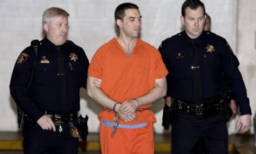 Convicted murderer Scott Peterson is escorted by two San Mateo County deputies as he is walked from the jail to an awaiting van March 17