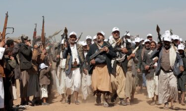 Houthi fighters march during a rally outside Sanaa