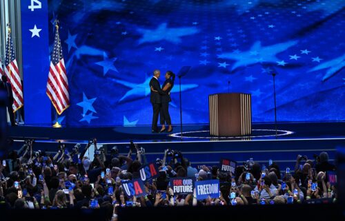 Former President Barack Obama and Michelle Obama embrace on stage on August 20