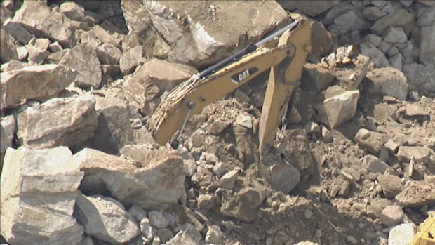 <i>WBZ via CNN Newsource</i><br/>The rock wall collapsed on top of the excavator at the quarry in Sterling on Thursday