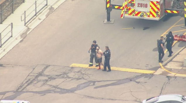 <i>KCNC via CNN Newsource</i><br/>The gunman is led away from the King Soopers store by first responders.