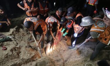 Teams conduct a search and rescue operation after Israeli airstrike on a tent encampment of displaced Palestinians in Al-Mawasi area of Khan Yunis