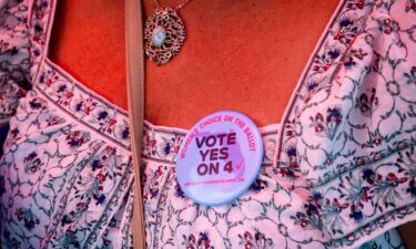 An attendee wears a "Vote Yes On 4" button during the kickoff of the Harris-Walz campaign reproductive rights bus tour in Boynton Beach